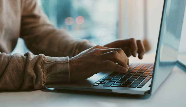 Photo shows a man working on his laptop/Getty Images
