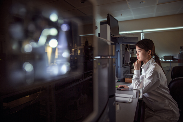A biochemist researches in a lab/Getty Images