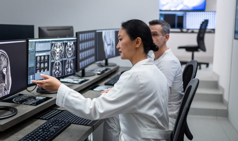 Photo shows two radiologists looking at scan after MRI in hospital laboratory/Getty Images
