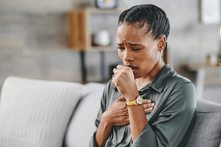 Photo shows close-up of woman coughing