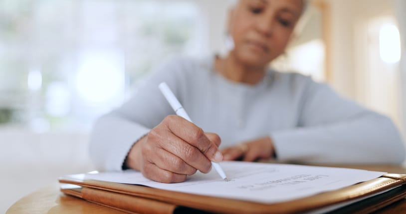 Photo shows woman making a list