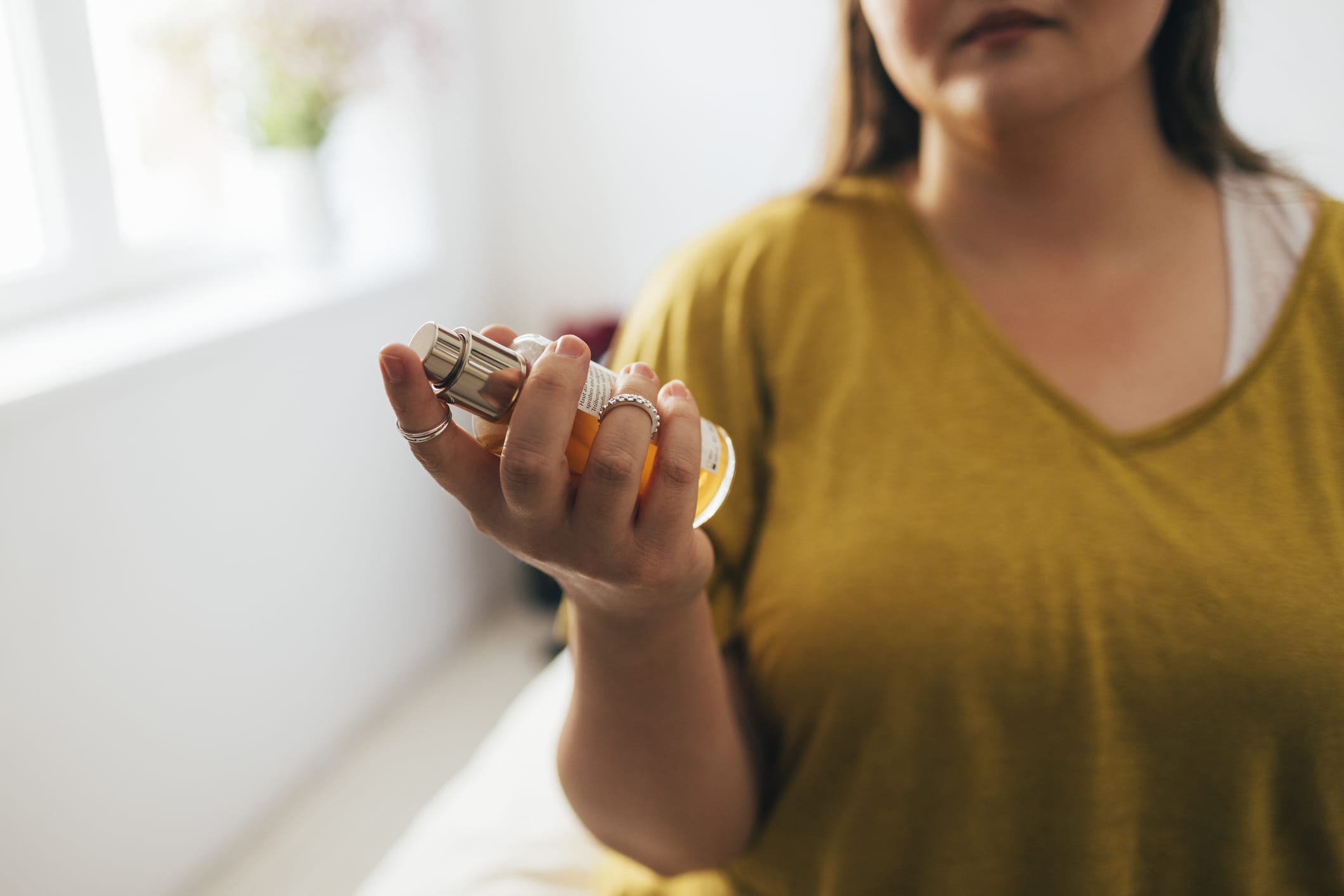 Photo of woman holding bottle of perfume
