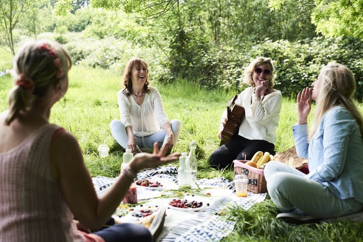 Photo of group of women having a picnic in a park