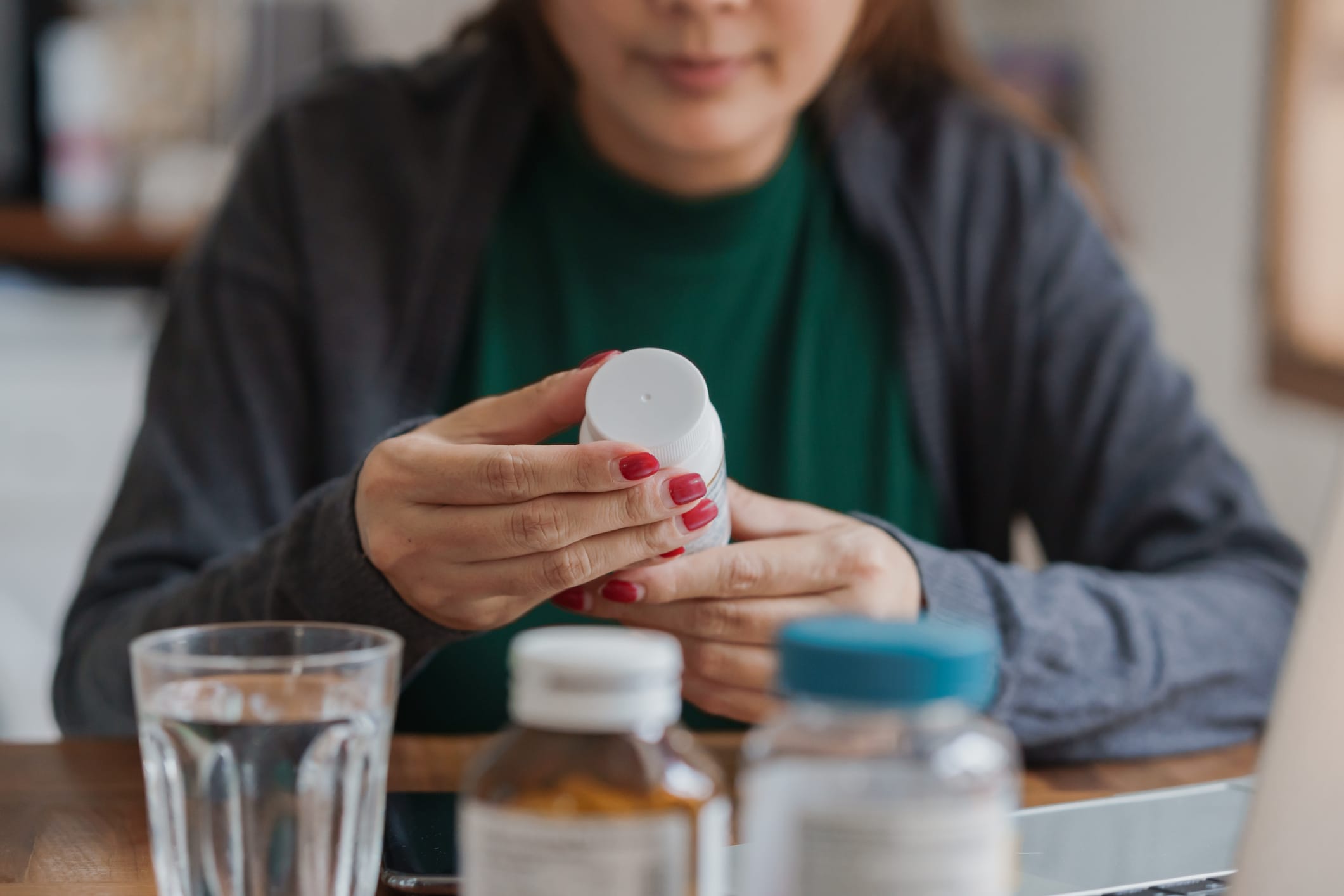 Close up of Asian female patient reading a dietary supplement label