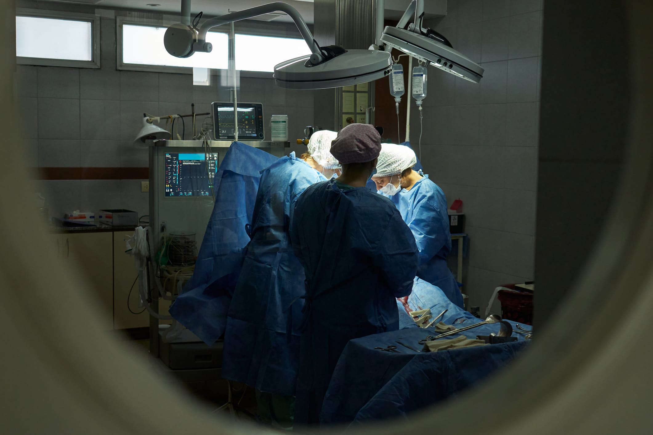 View from outside the delivery room of a woman giving birth
