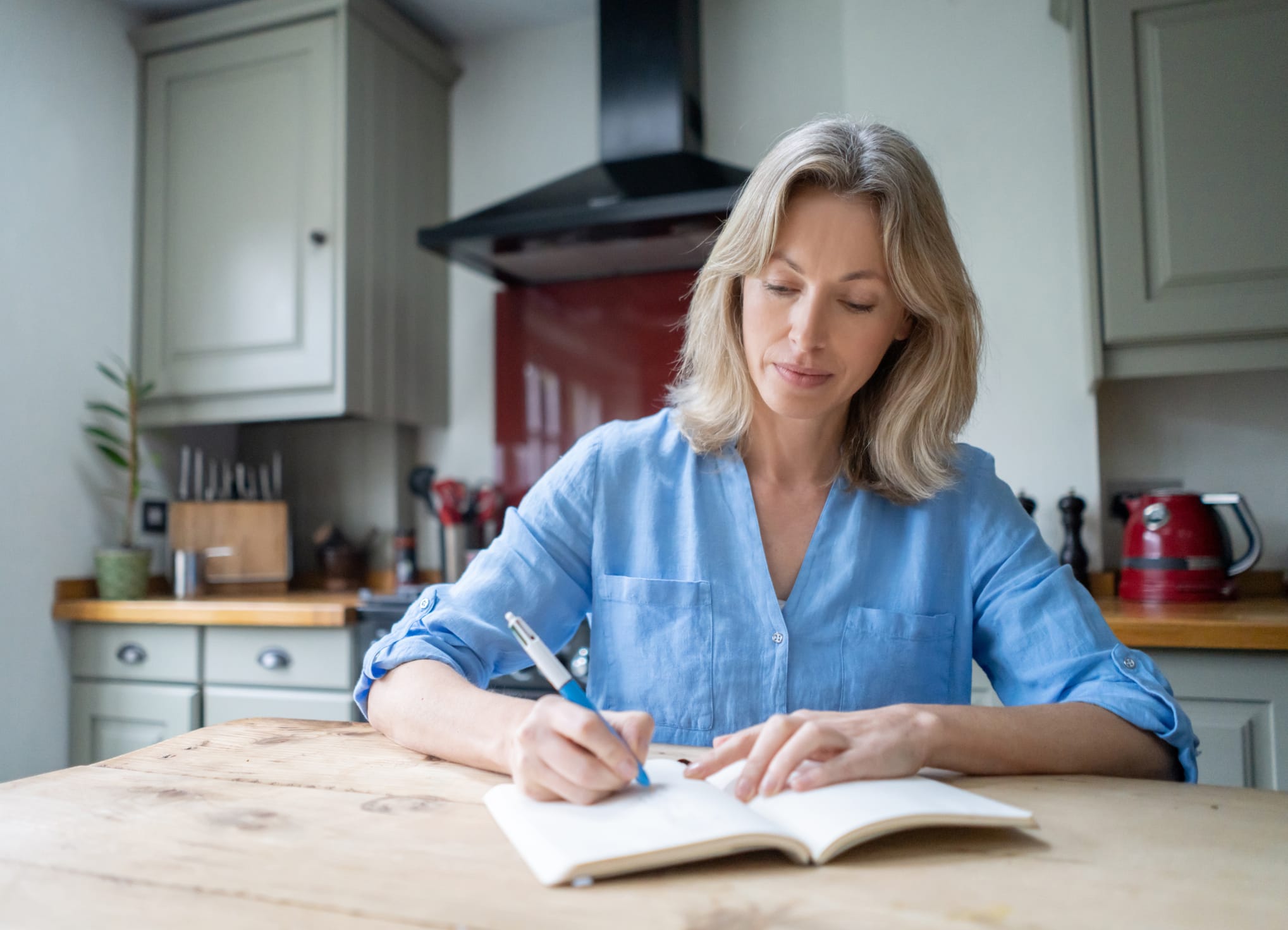 Woman writing in symptom diary