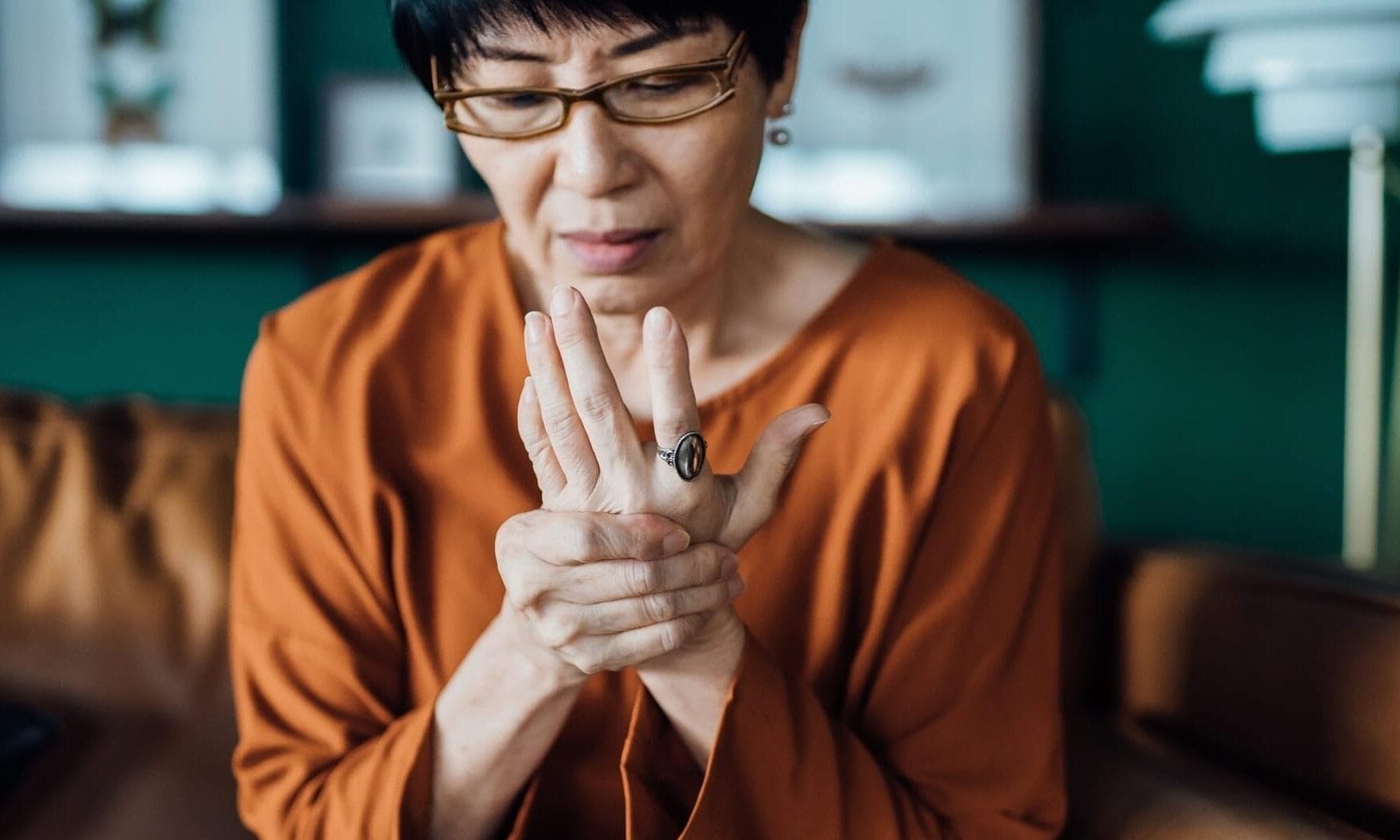 Older woman rubbing painful hand