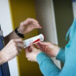 Woman pointing to a pain scale for healthcare provider