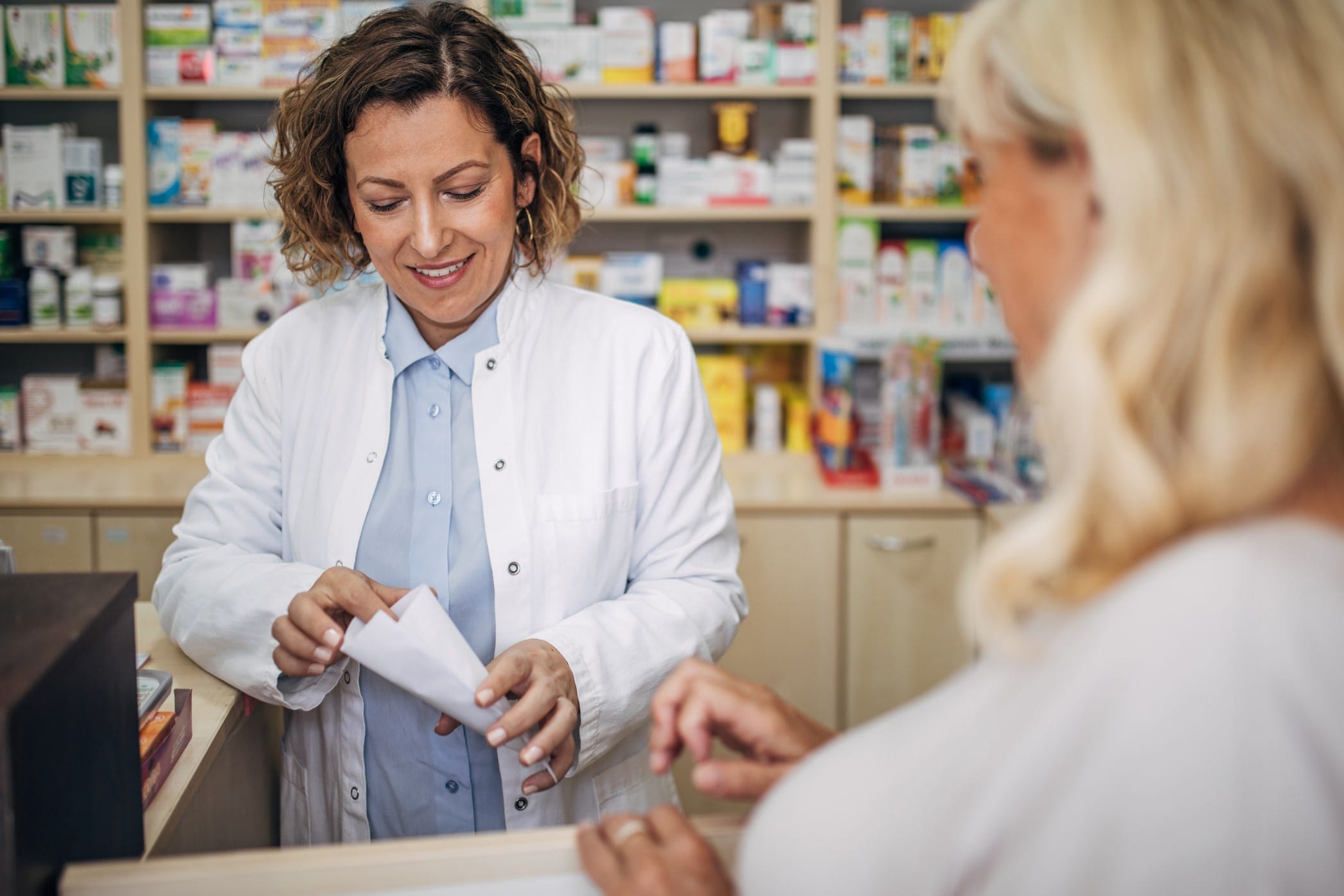 Pharmacist helping customer with medication