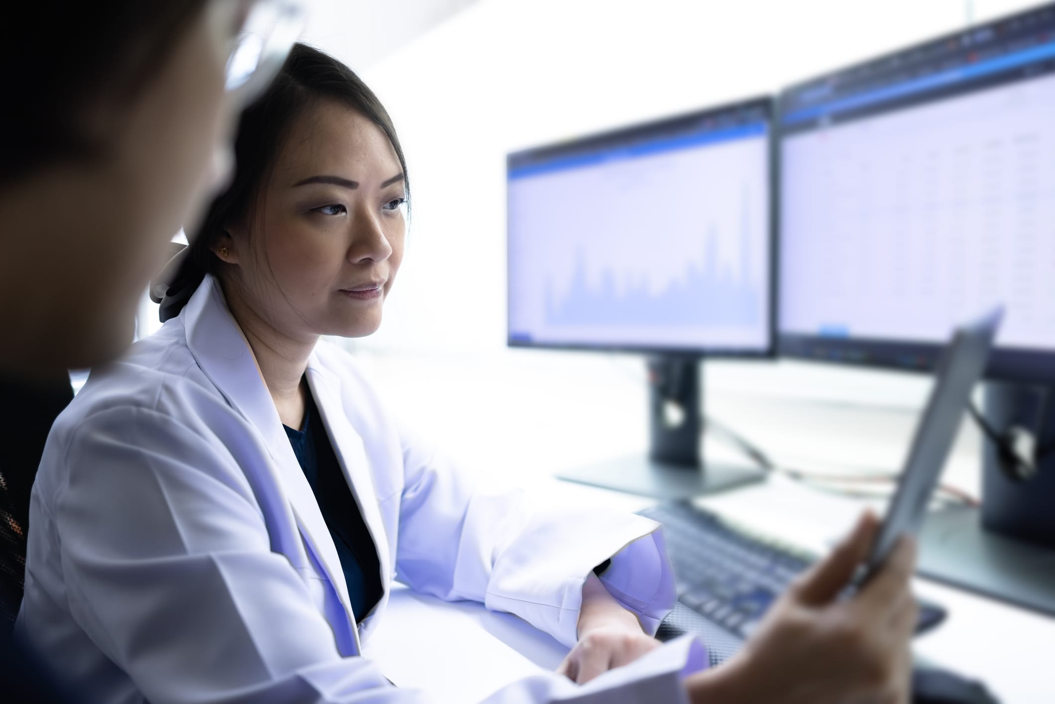 Researchers reviewing data on a computer screen