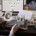 Person researching family history looking at old photos