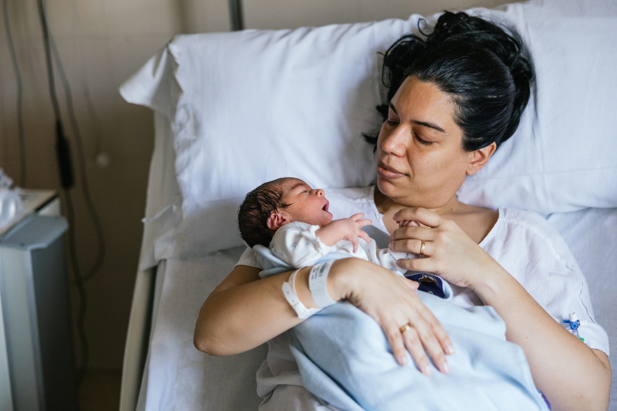 Woman in hospital bed with newborn baby