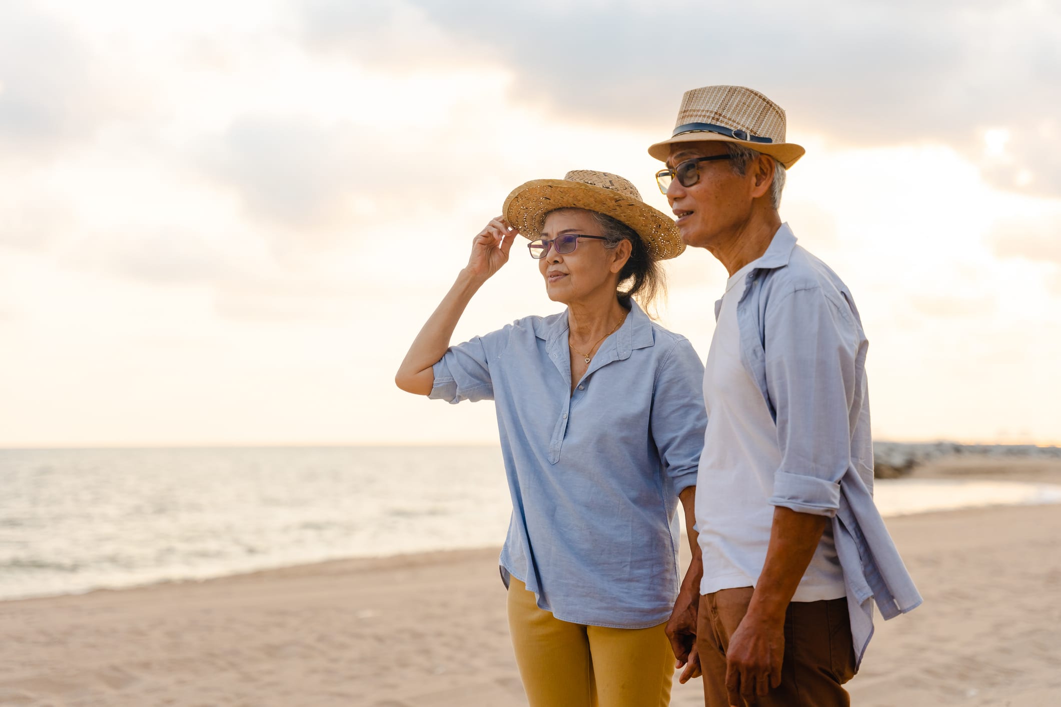 Older couple on the beach at sunset
