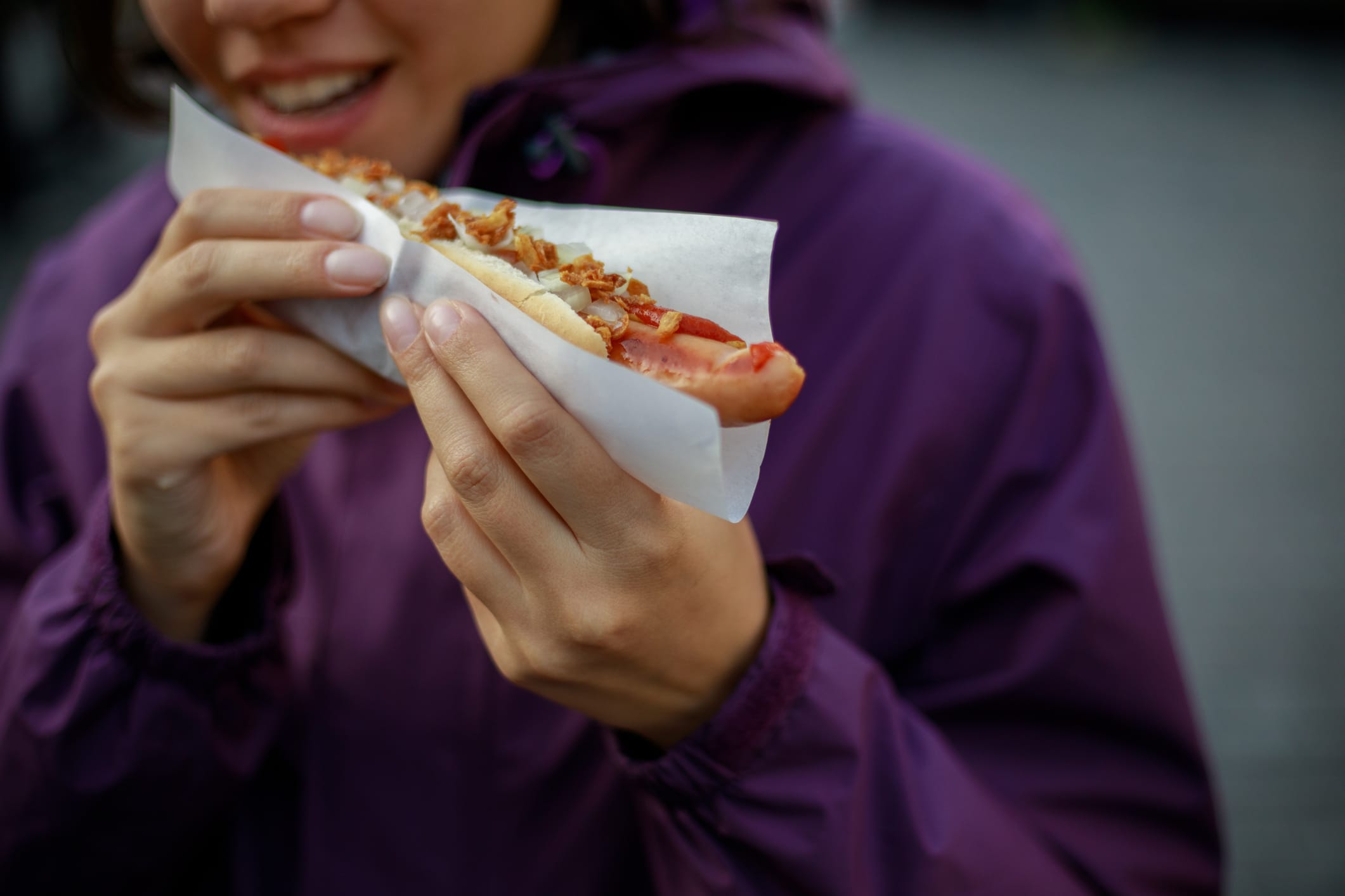 Woman about to eat a hot dog