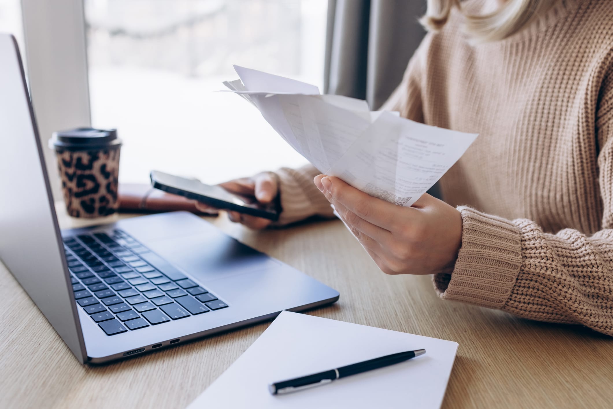 Woman sitting in front of laptop paying bills