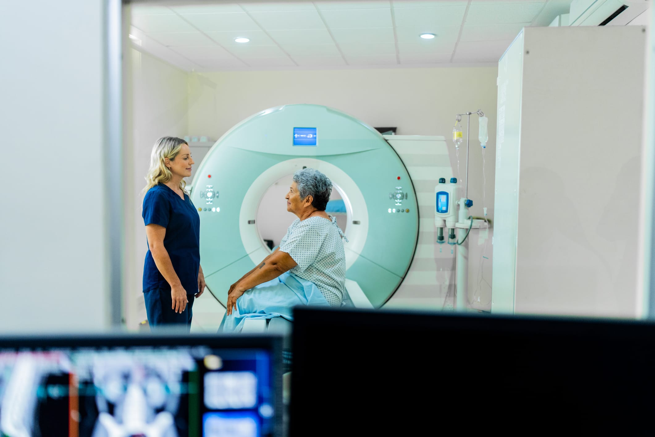 Care provider talking to patient before a CT scan