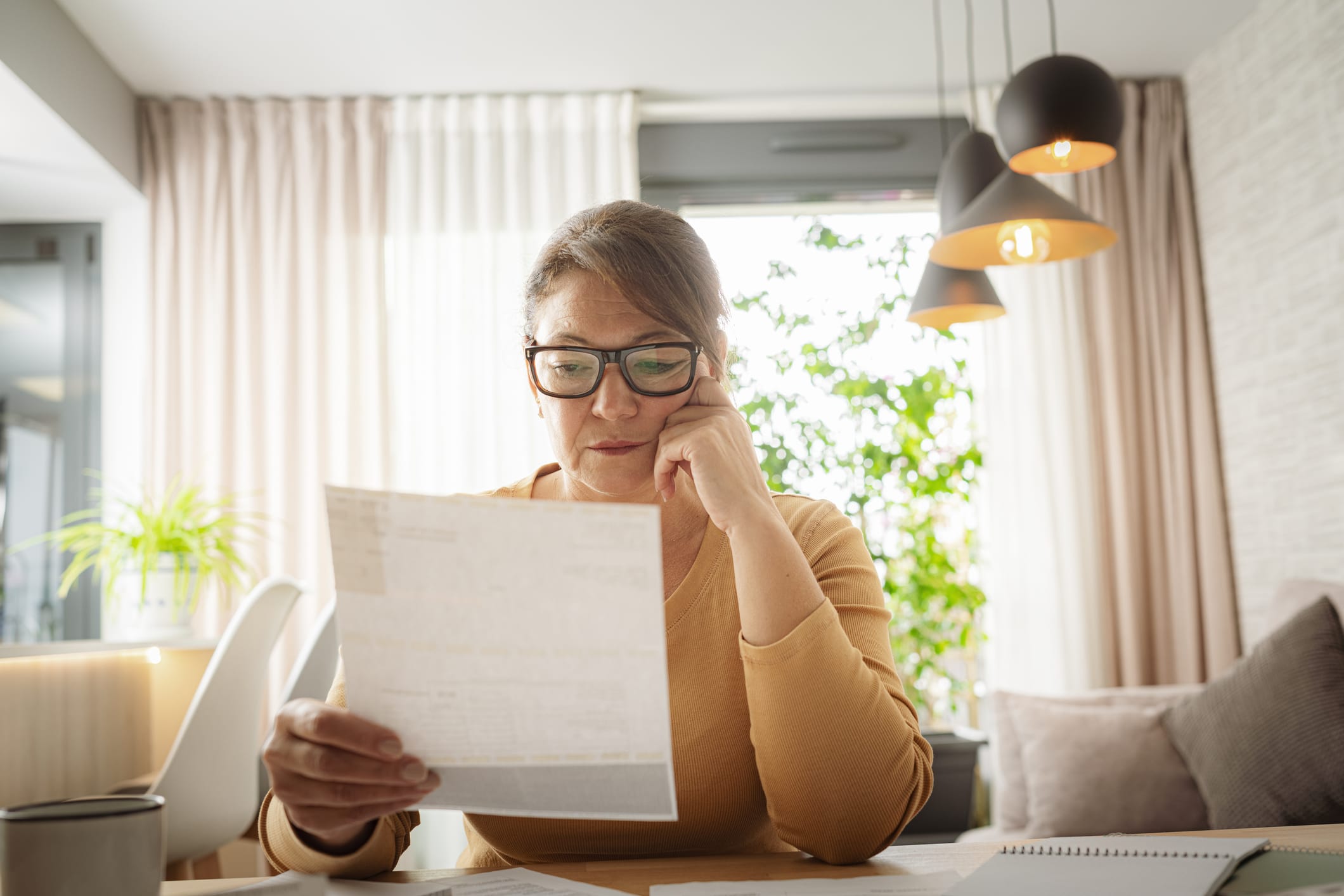 Woman reading medical bills