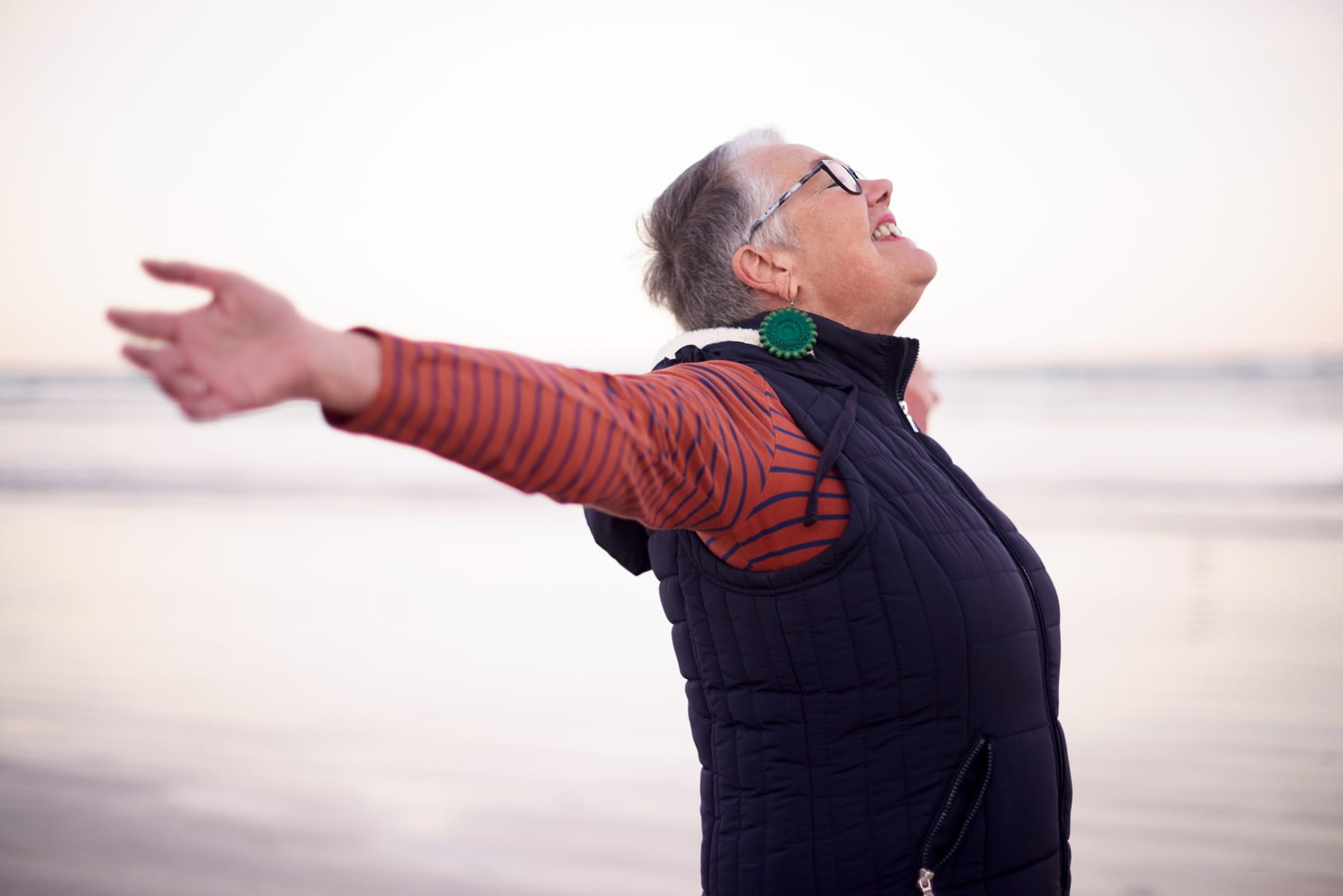 Shot of a happy senior woman enjoying a day at the beach