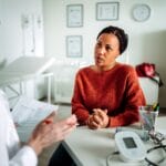 Patient listening to doctor in office