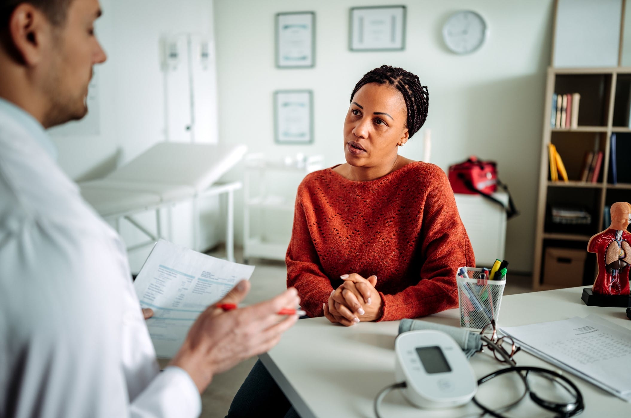 Patient listening to doctor in office