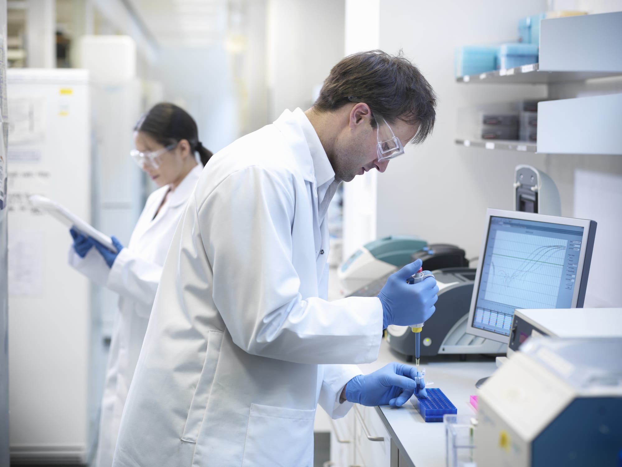 Scientists performing genetic testing in a lab