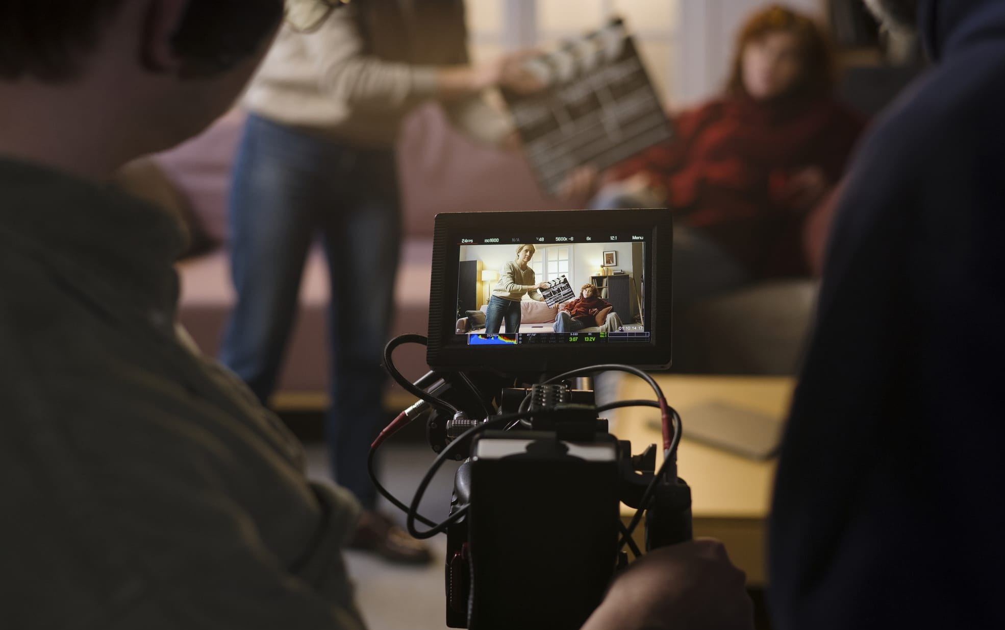 A camera operator films on set
