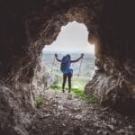 Woman hiking in a cave