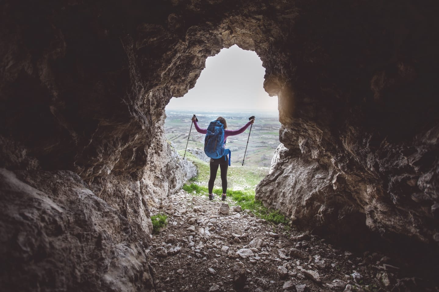 Woman hiking in a cave