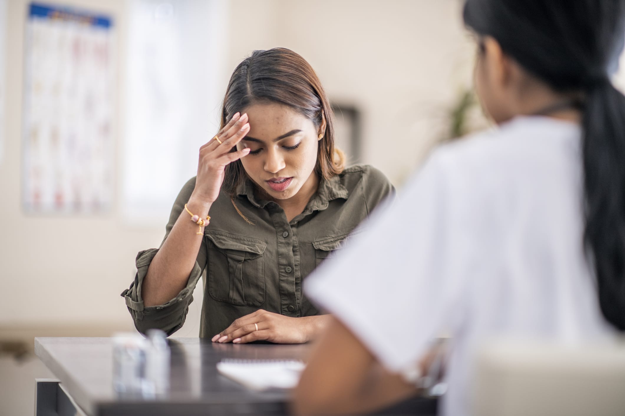 Frustrated woman talking with medical professional